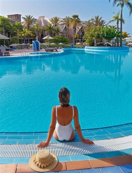 NHS staff relaxing by pool in H10 Hotel. 